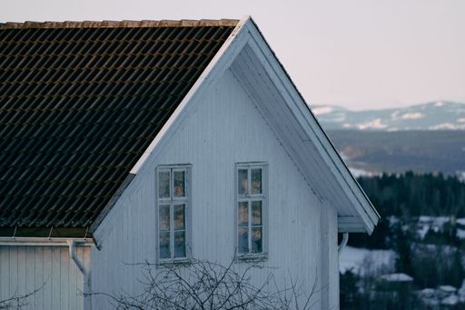 A scenic view of a wooden hour in winter in Toten, Norway