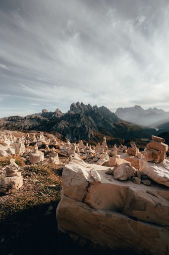 A majestic vertical shot of balanced stone pyramids in the Dolomites Mountain Range, Italy