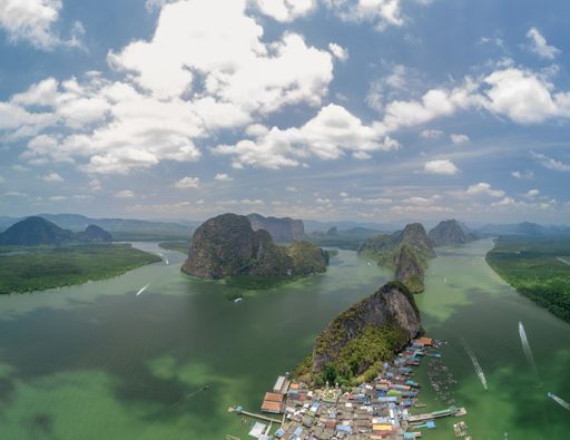 An aerial shot of a village and towering islands of Koh panyi, Thailand