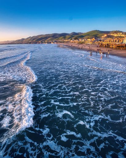 A scenic view of a people on the Pismo Beach, CA at sunset