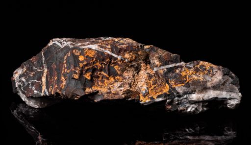 A mineral rock with some crystallized parts on the black background
