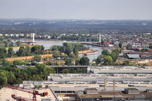 An aerial view of a bustling city skyline and construction sites near the river Rhine in Cologne, Germany