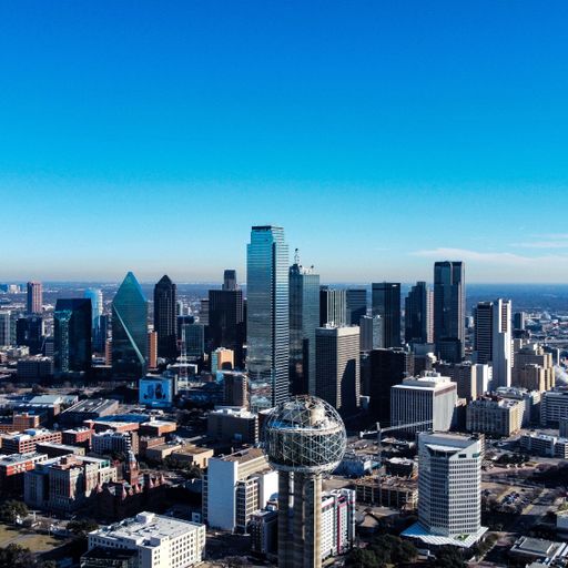 An aerial view of the cityscape of Dallas, Texas on a sunny day