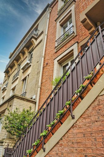 A scenic view of beautiful buildings on a sunny day in Paris, France