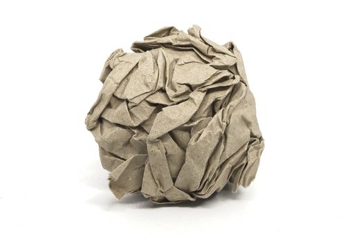 A crumpled piece of recycled paper isolated on white background - green waste concept