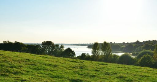 Majestic view of lush green hill overlooking blue ocean