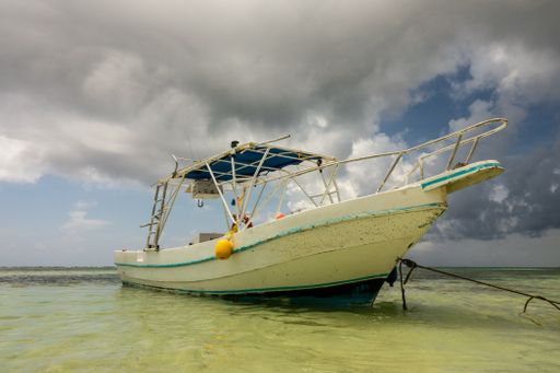 A low angle shot of a ship in the water under a cloudy sky