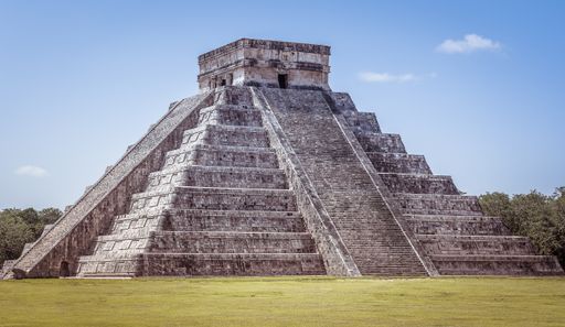 A closeup shot of Chichen Itza in Mexico under a clear blue sky