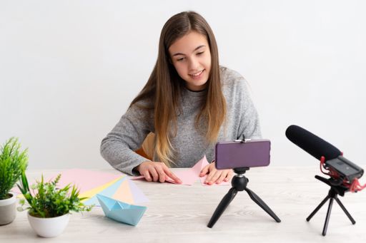 A Caucasian woman doing an origami tutorial - the concept of blogging