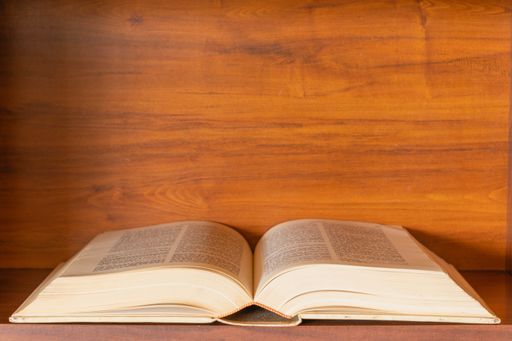 An open bible on a wooden background