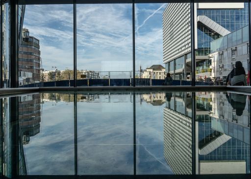 A wide angle shot of several urban buildings under a clear blue sky