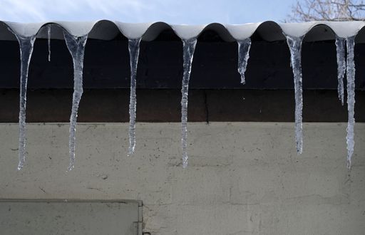 A closeup shot of a row of icicles on a roof