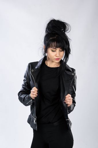 A young fashion model from Bosnia and Herzegovina in fashionable clothes posing on white background