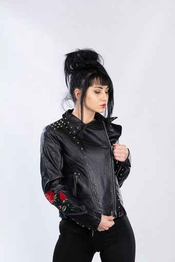 A fashion model from Bosnia and Herzegovina in a leather jacket posing against a white background