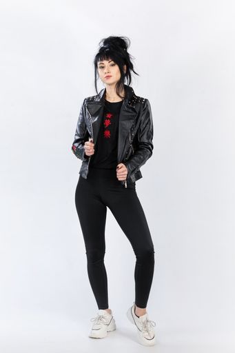 A fashion model from Bosnia and Herzegovina in a leather jacket posing against a white background