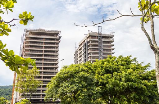 A low angle shot of two high-rise buildings under constructi