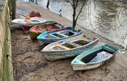 Old wooden boats abandoned on the banks of the Pisuerga river near Valladolid