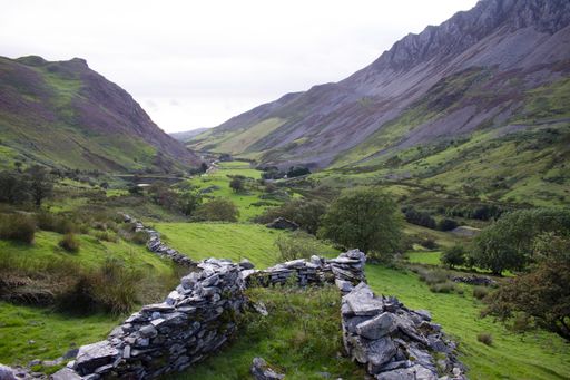 A beautiful shot of a valley covered in grass and stone walls in Snowdonia National Park, UK