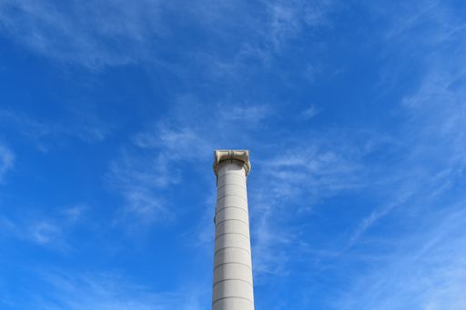 A low angle shot of a column with clear blue sky in the background