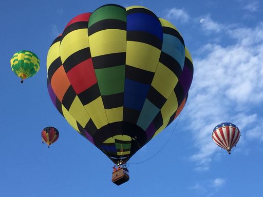 A beautiful shot of colorful hot air balloons flying in the blue sky