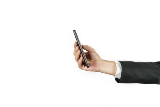 A closeup shot of a male in a suit holding a phone on an isolated background