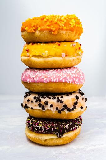 A variety of colorful donuts arranged on a table against a white background