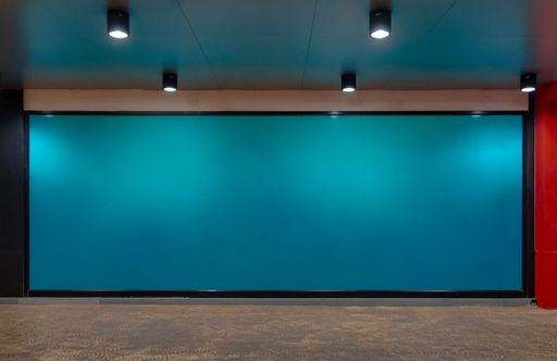 A modern studio interior with a blank blue wall.