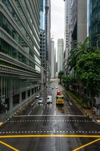 Car traffic downtown Singapore. Central Business District on a rainy day. Vertical shot