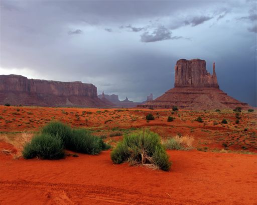 A breathtaking view of sandstone formations against dark stormy sky in Monument Valley