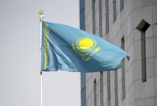 A national flag of Kazakhstan waving from wind in Almaty