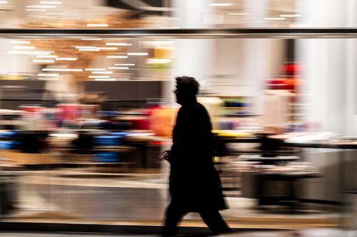 A wide angle shot of a person rushing through  a room full of items
