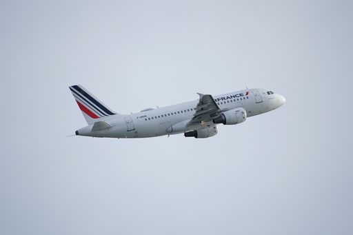 A commercial Air France airplane flying through a clear sky