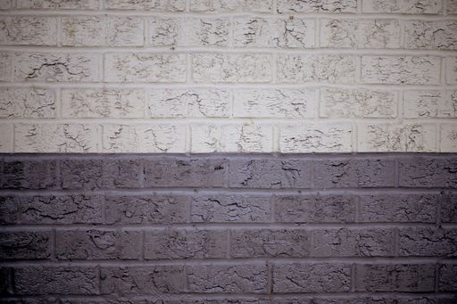 A closeup shot of a grey and white wall made of rectangular stones