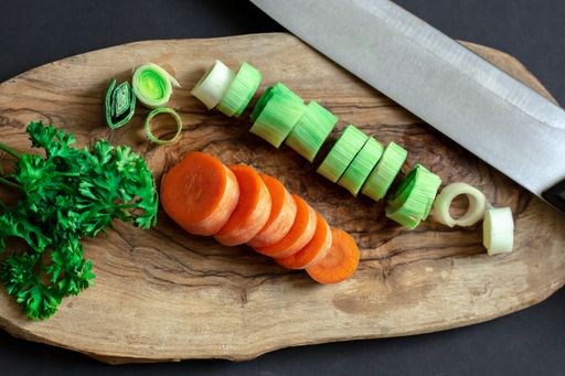 A birdseye view of several chopped vegetables on a cutting board