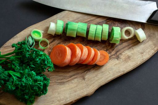 A birdseye view of several chopped vegetables on a cutting board