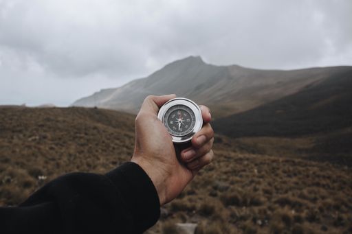 A closeup shot of a person holding a compass