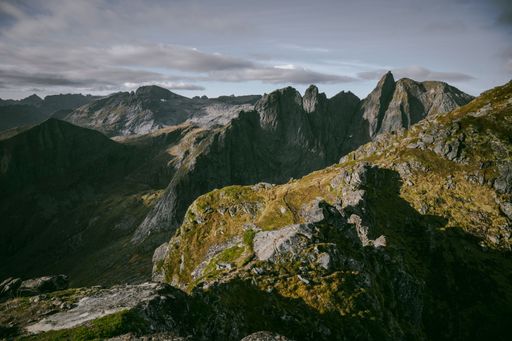 A landscape view of the rocky mountains against a clouded sky
