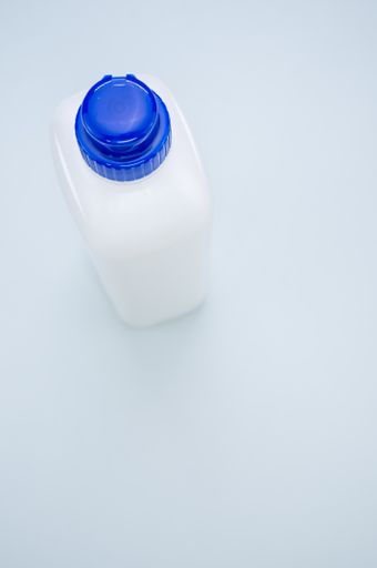 A top view of a plastic bottle with a blue cap isolated on a white background