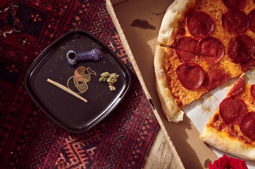 Hemp/Cannabis CBD/THC Joint and flower with box of pizza on the floor.