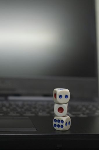 A vertical shot of dice on a grayscale background