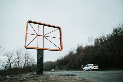 An empty road sign frame with cars on the road to Bansko