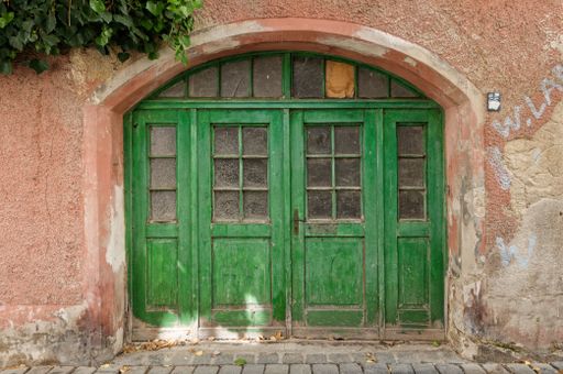 A green door in an old building facade
