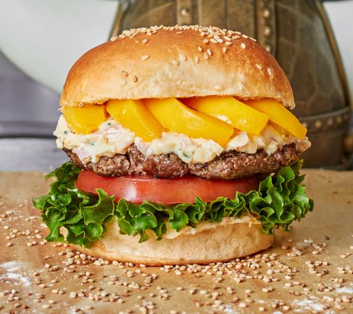 A closeup shot of a delicious burger on a wooden surface