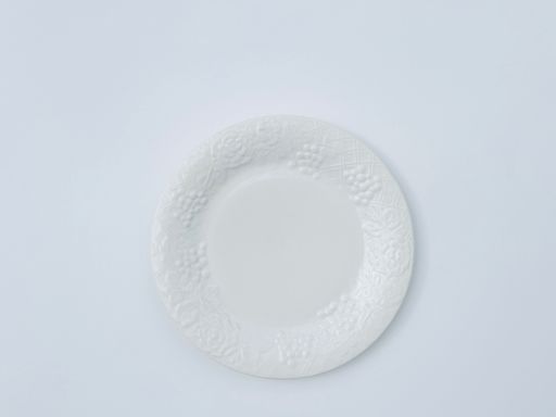 A top view of a white decorative plate isolated on white background