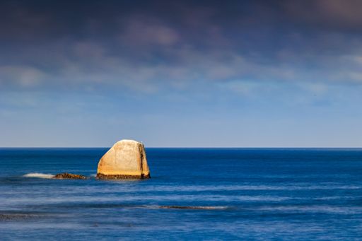 An idyllic summer scene featuring a stunning ocean view with a clear blue sky