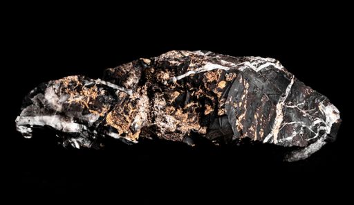 Macro Close up image of raw material Manganese Ore rock isolated on black reflective background