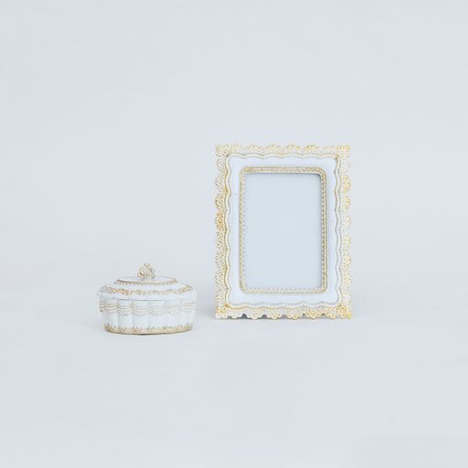 An old-fashioned photo frame and a casket on a white background