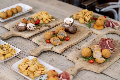Fresh delicious food served on wooden boards in a restaurant