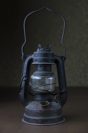 A vertical shot of an old metal vintage lamp