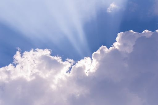 A beautiful blue sky with sunlight coming through clouds